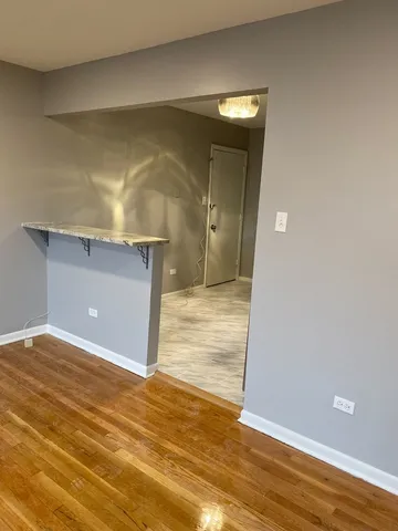a view of a livingroom with wooden floor and cabinet
