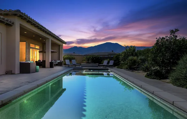 a swimming pool with outdoor seating