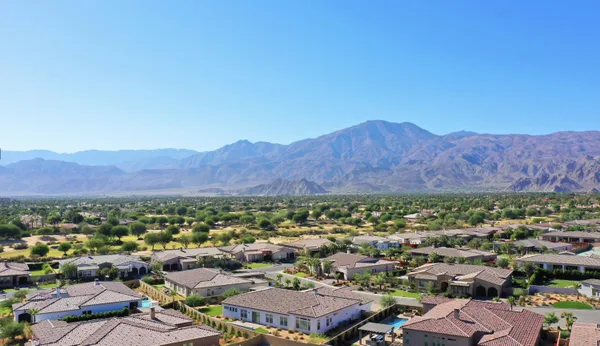 an aerial view of residential house and sandy dunes