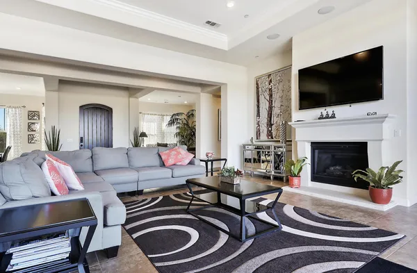 a living room with fireplace furniture and a flat screen tv