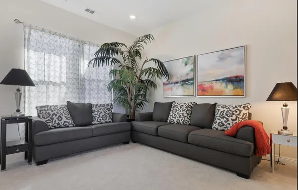 a living room with furniture and a large window