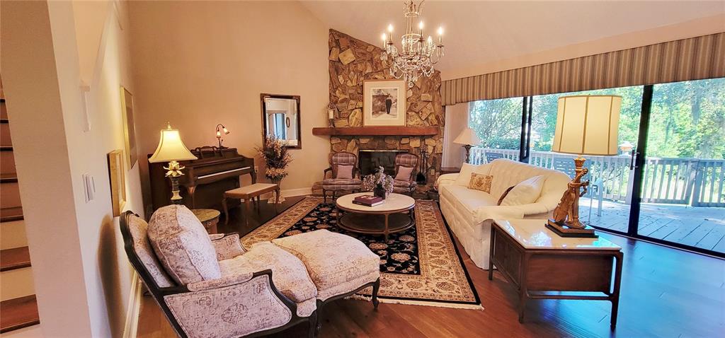 1004 Old Mill Pond Road Palm Harbor, FL 34683 - Photo 12 of 48 a living room with furniture fireplace and large windows