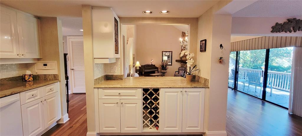 1004 Old Mill Pond Road Palm Harbor, FL 34683 - Photo 17 of 48 a kitchen with white cabinets and sink