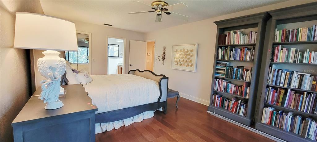 1004 Old Mill Pond Road Palm Harbor, FL 34683 - Photo 37 of 48 a bed room with a bed and a book shelf