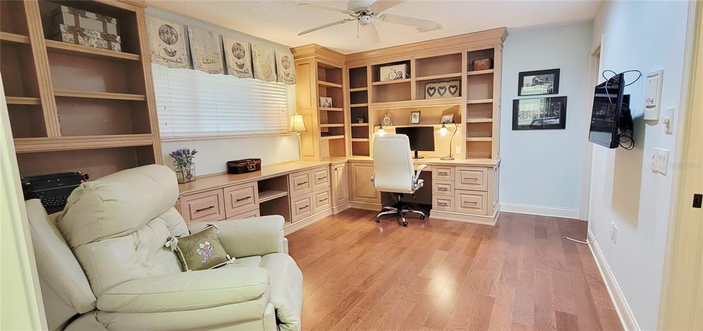 1004 Old Mill Pond Road Palm Harbor, FL 34683 - Photo 44 of 48 a living room with furniture a rug and a wall painting