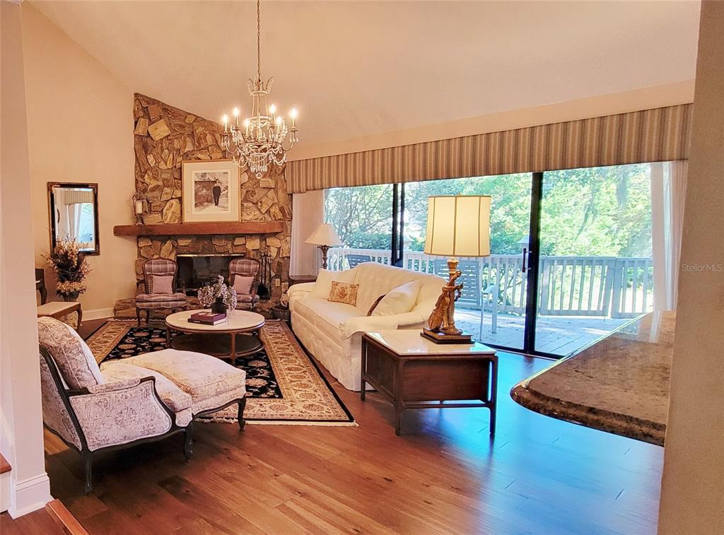 1004 Old Mill Pond Road Palm Harbor, FL 34683 - Photo 5 of 48 a living room with furniture and a chandelier