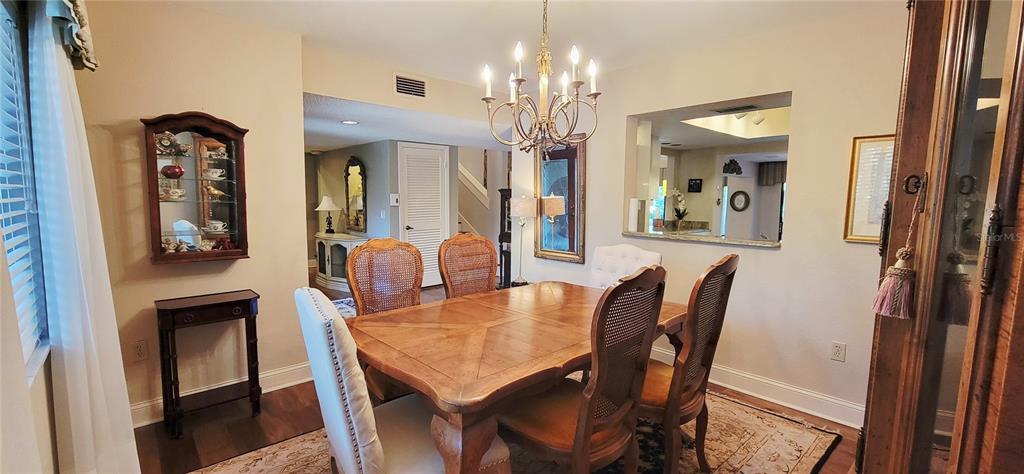 1004 Old Mill Pond Road Palm Harbor, FL 34683 - Photo 9 of 48 a view of a dining room with furniture and a chandelier