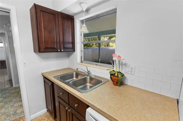 a kitchen with refrigerator a sink and dishwasher