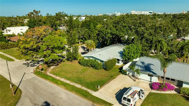 a view of a hallway with wooden floor and windows