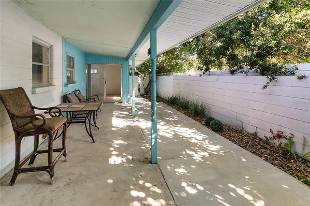 a view of a patio with table and chairs and potted plants