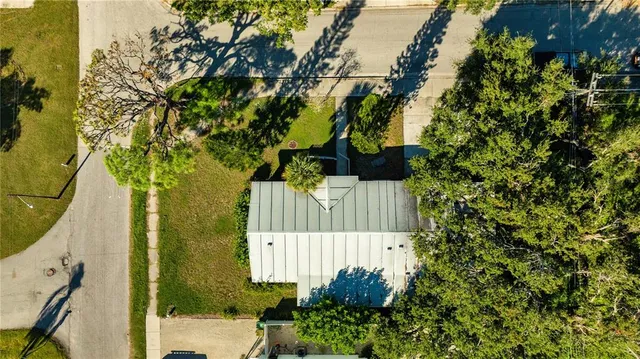 a view of a patio with table and chairs and potted plants