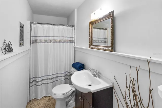 a bathroom with a shower and a sink mirror