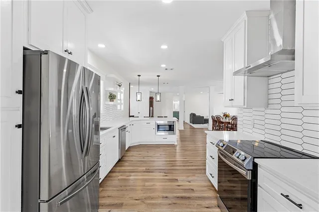 a kitchen with stainless steel appliances a refrigerator stove and sink