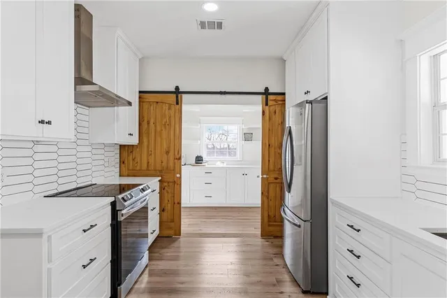 a kitchen with stainless steel appliances a stove and a refrigerator