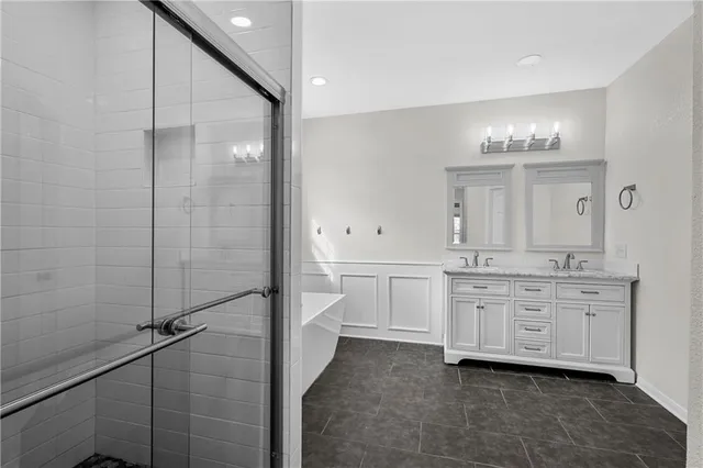 a bathroom with a double vanity sink a mirror and a shower