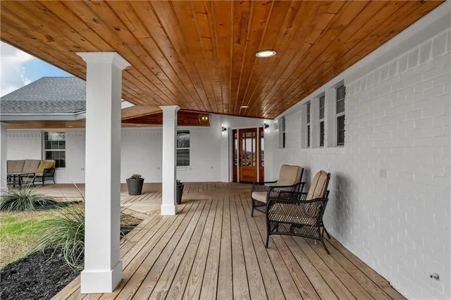 a view of a patio with table and chairs and wooden floor