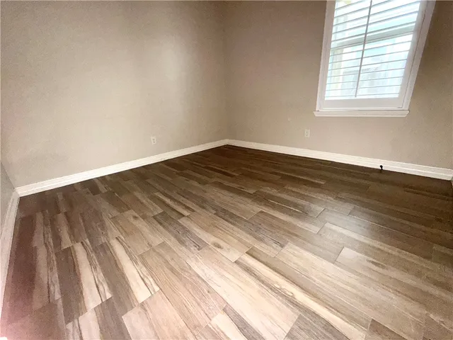a view of a room with wooden floor and natural light