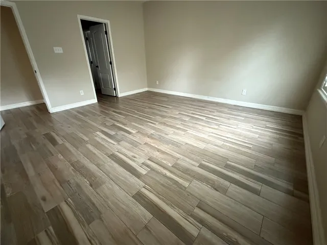 a view of an empty room and wooden floor