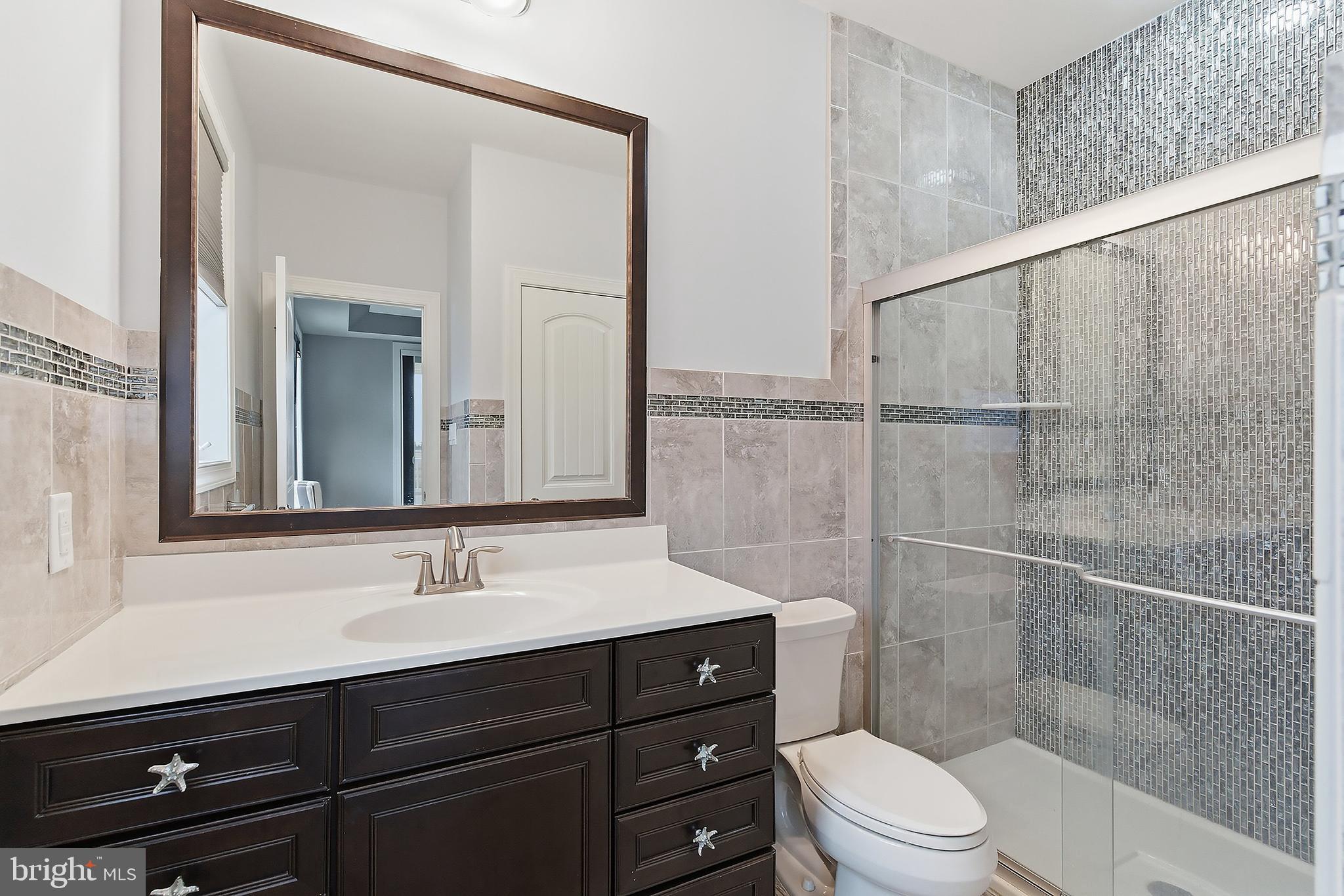 23 East Pimlico Road Little Egg Harbor, NJ 08087 - Photo 20 of 43 a bathroom with a sink a toilet a mirror and shower