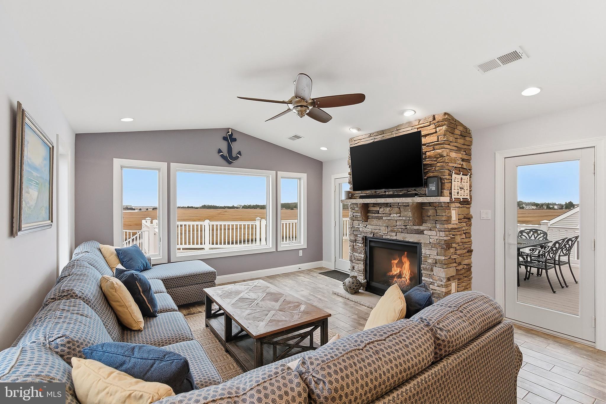 23 East Pimlico Road Little Egg Harbor, NJ 08087 - Photo 23 of 43 a living room with couches a fireplace and a flat screen tv