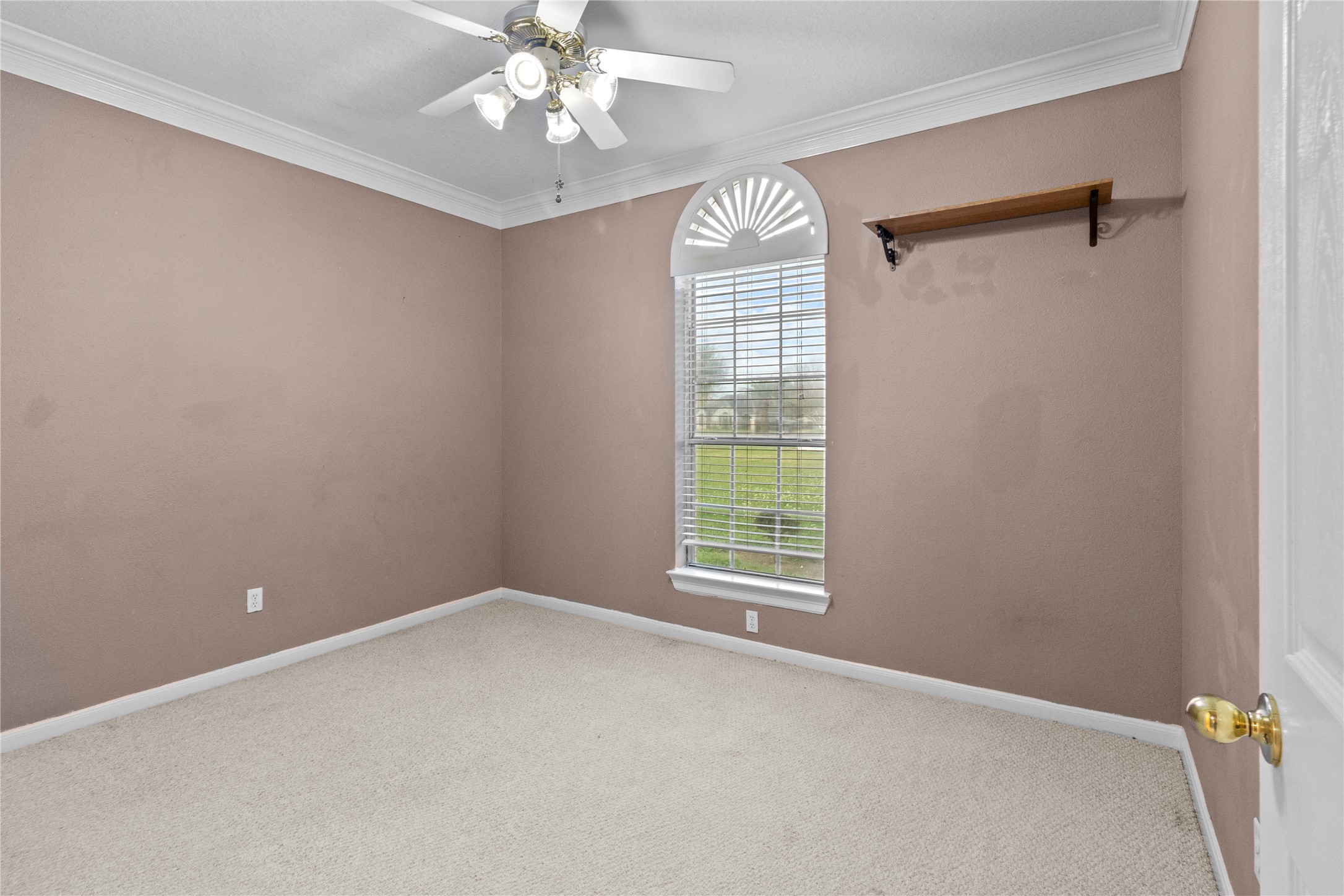 10302 Hanselman Road, Unit CR69 Manvel, TX 77578 - Photo 14 of 37 an empty room with a window and chandelier fan