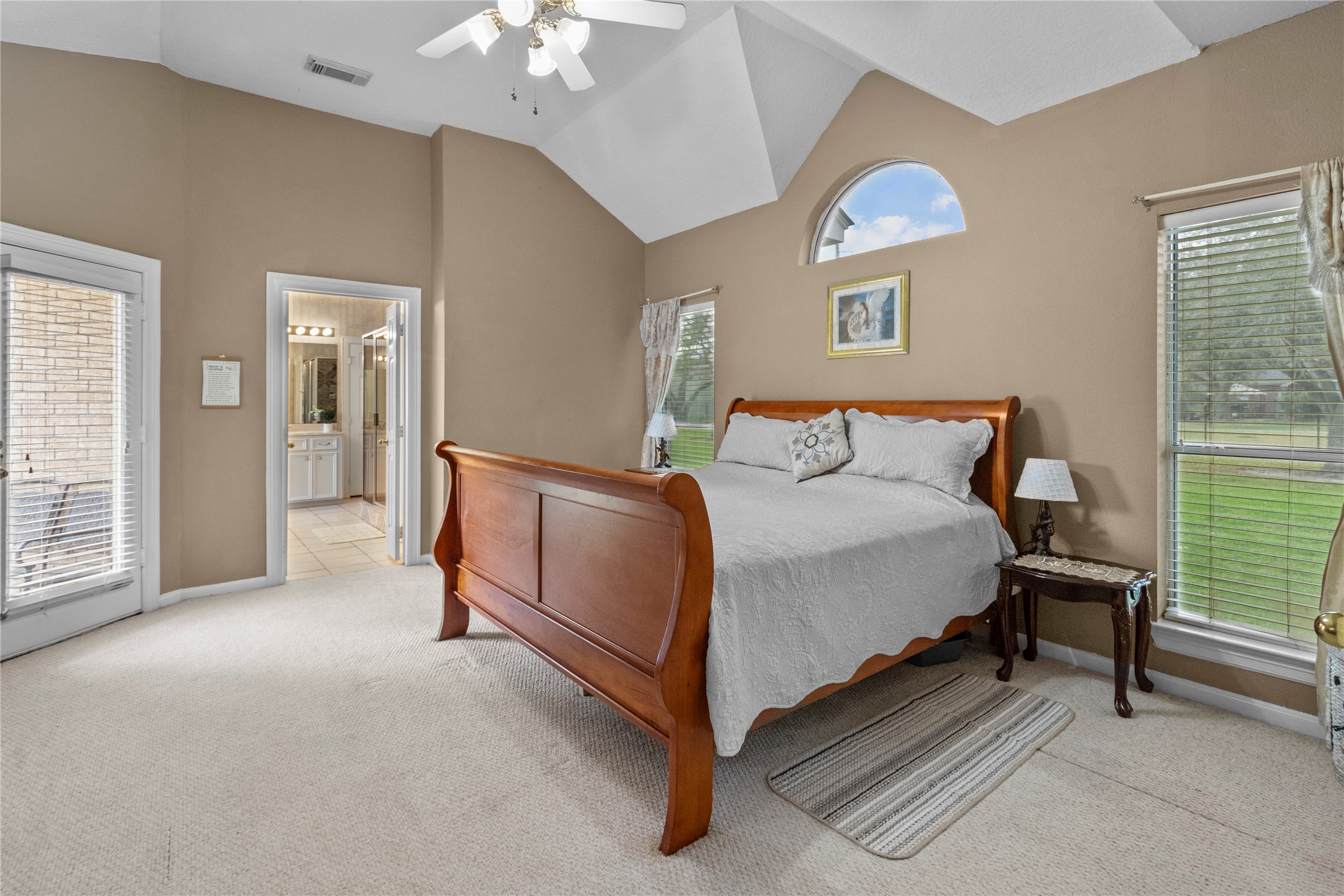 10302 Hanselman Road, Unit CR69 Manvel, TX 77578 - Photo 16 of 37 a spacious bedroom with a bed and a chandelier