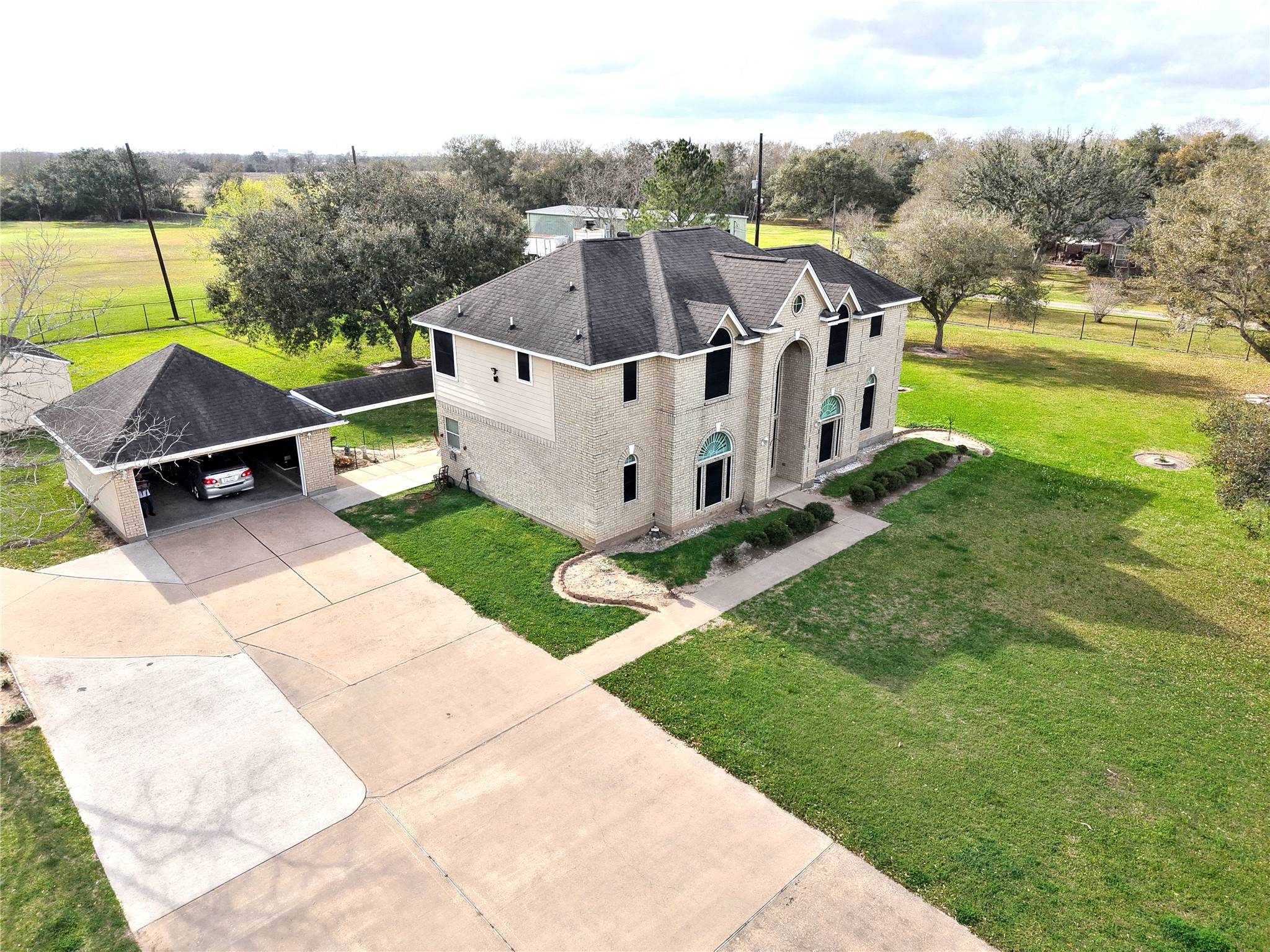 10302 Hanselman Road, Unit CR69 Manvel, TX 77578 - Photo 2 of 37 a view of a house with a yard and sitting area