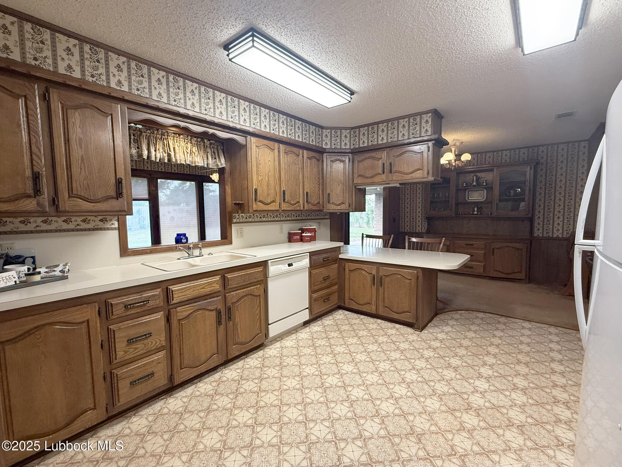 101 Dana Avenue Earth, TX 79031 - Photo 12 of 29 a large kitchen with kitchen island a sink stainless steel appliances and cabinets