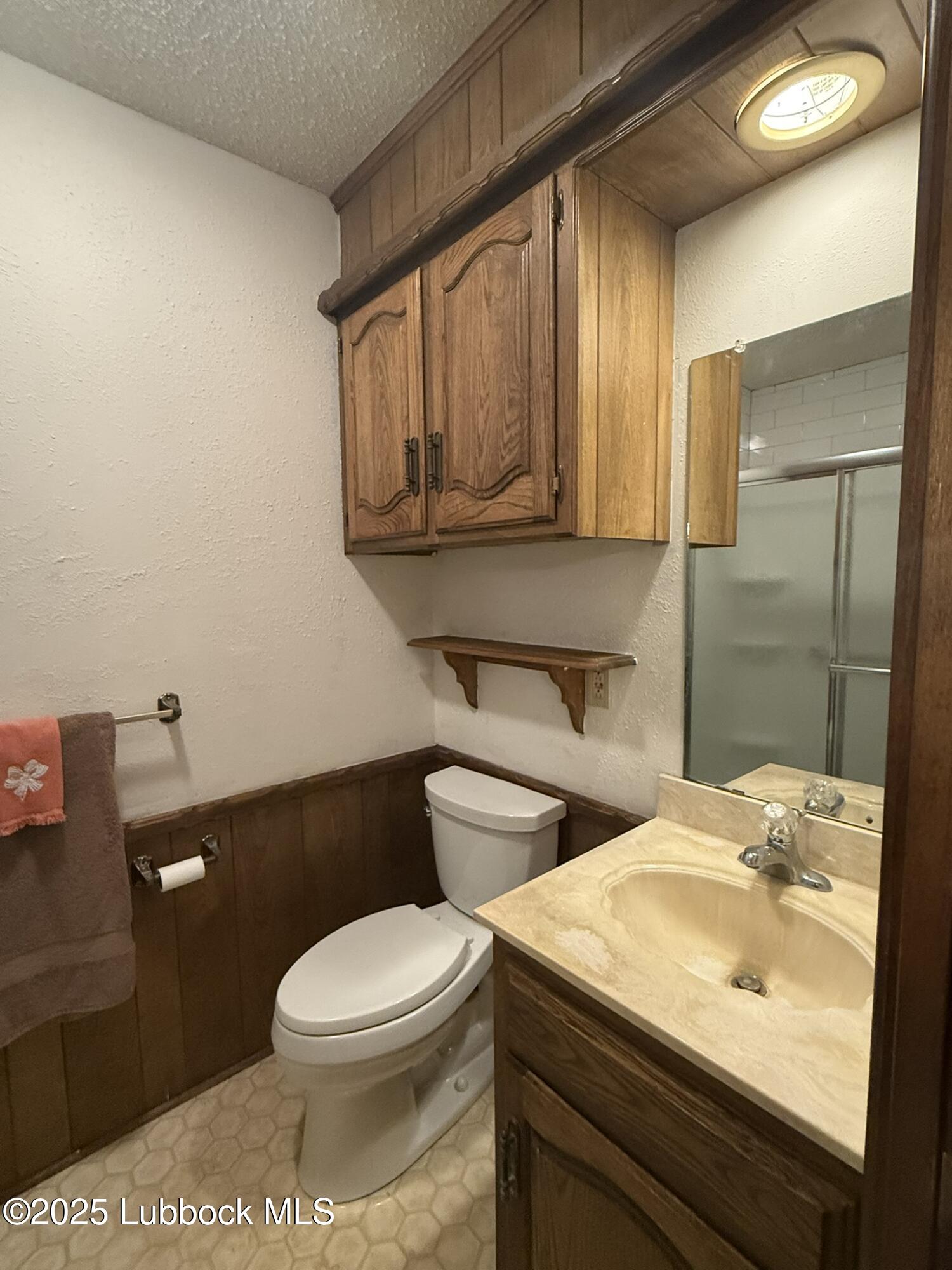 101 Dana Avenue Earth, TX 79031 - Photo 18 of 29 a bathroom with a sink a toilet and mirror