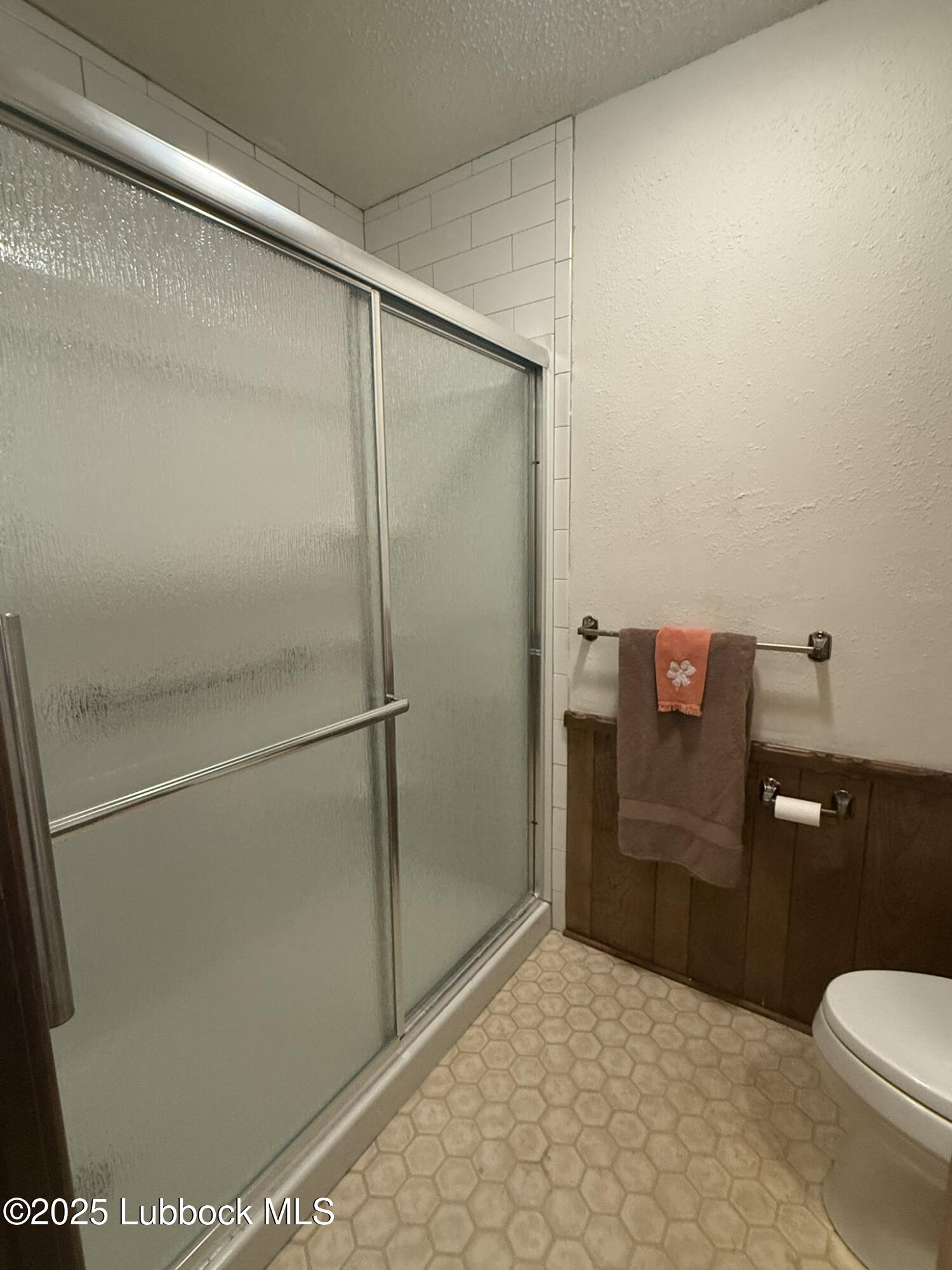 101 Dana Avenue Earth, TX 79031 - Photo 19 of 29 a bathroom with a granite countertop shower and a toilet