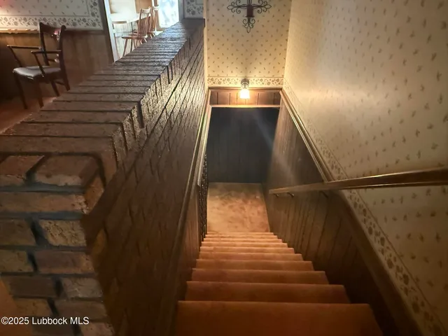 a bedroom with a bed chandelier and a window