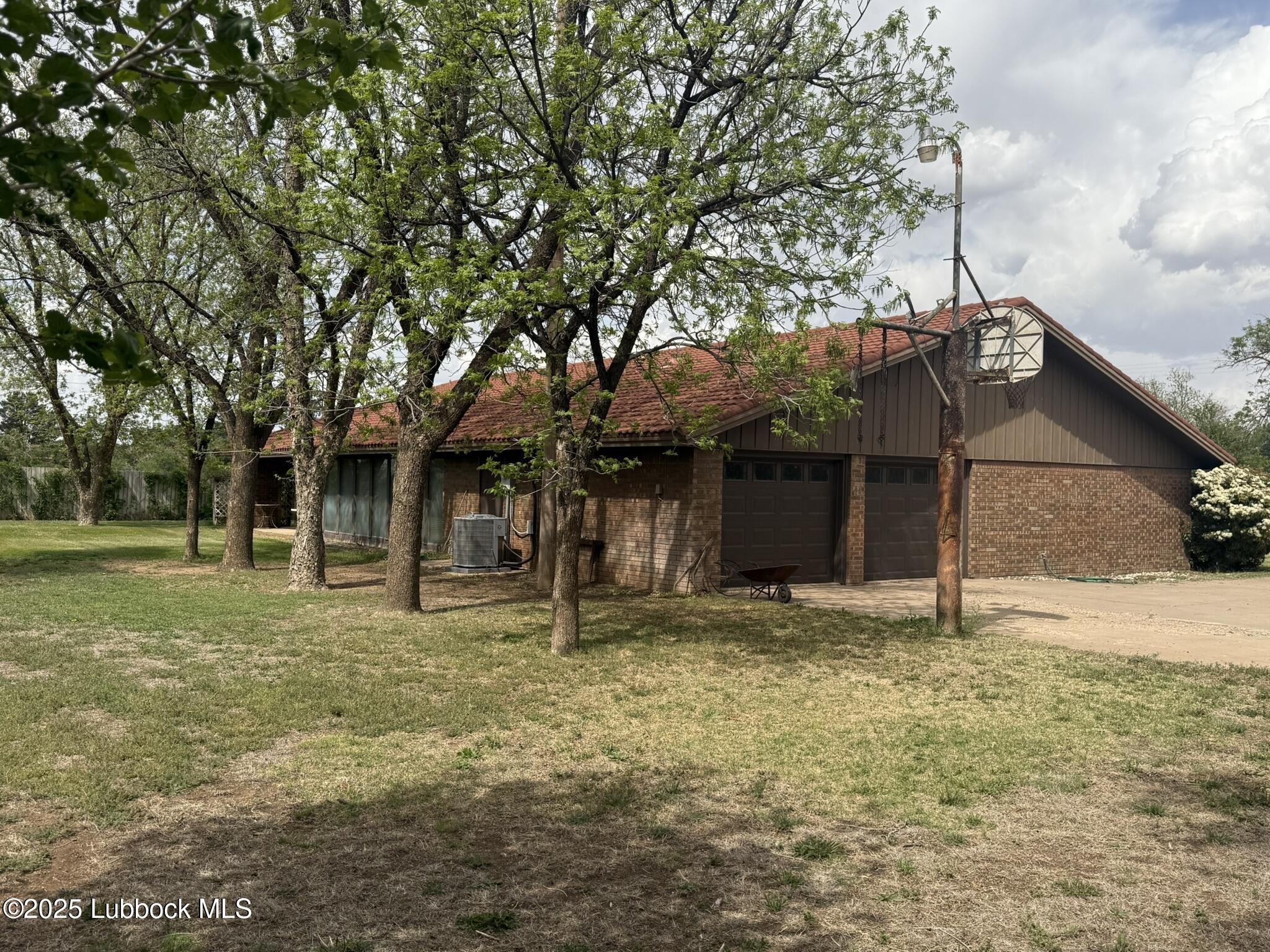 101 Dana Avenue Earth, TX 79031 - Photo 3 of 29 a house with trees in front of it