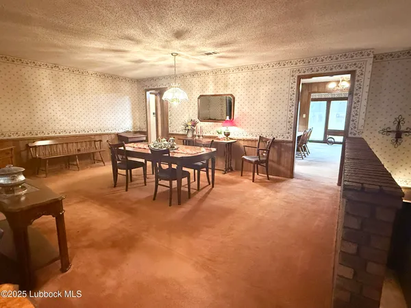 a view of a dining room with furniture and chandelier