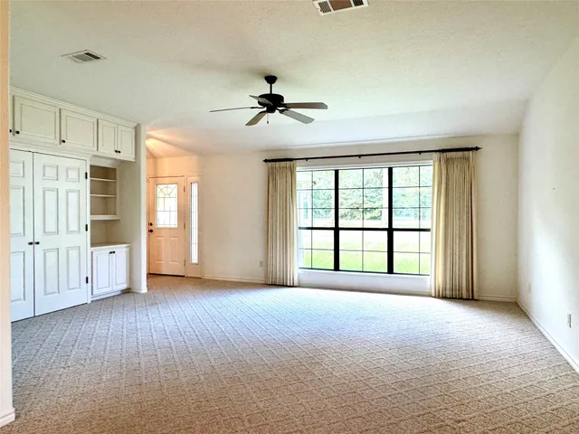 a room with pool table and windows