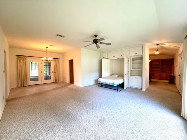 a view of an empty room with a fireplace and a window