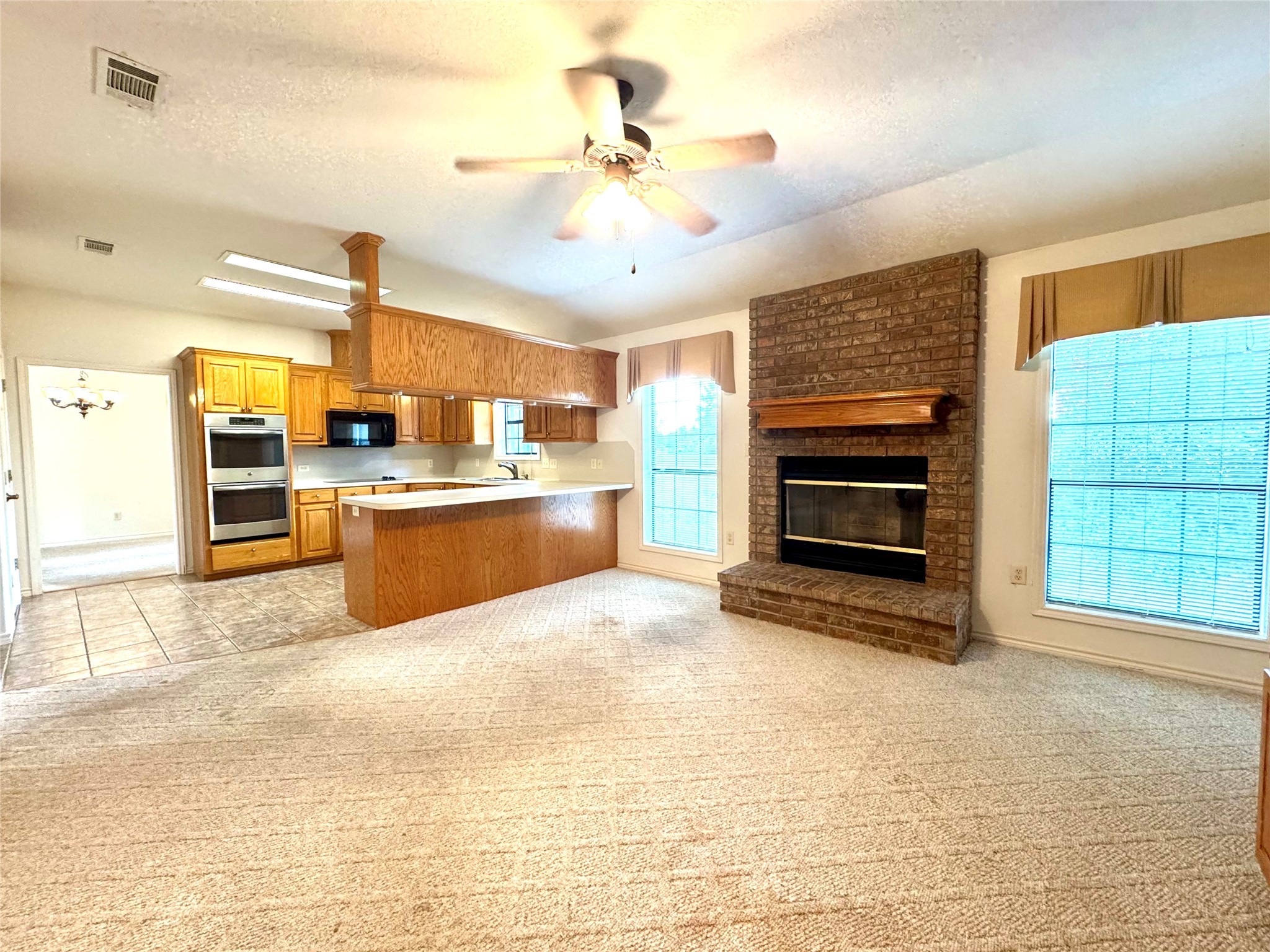 20 Shallow Springs Trinity, TX 75862 - Photo 20 of 48 a view of a kitchen with a stove cabinets a ceiling fan and wooden floor