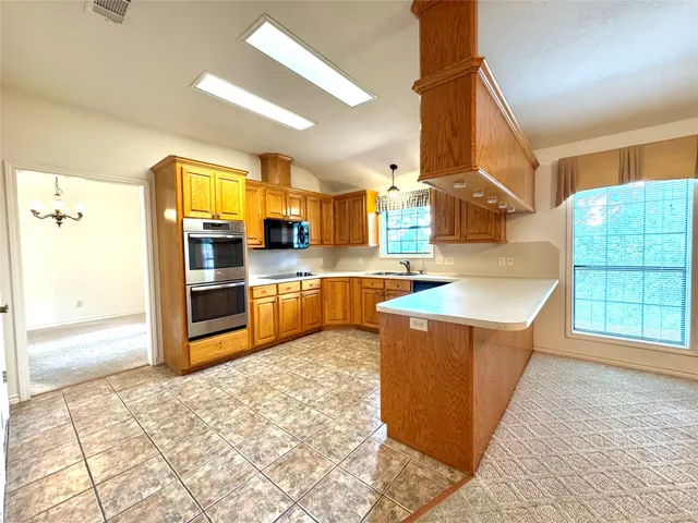 a spacious bathroom with a granite countertop sink and a mirror