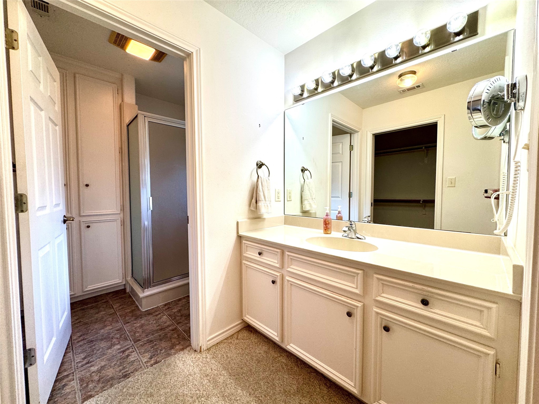 20 Shallow Springs Trinity, TX 75862 - Photo 32 of 48 a spacious bathroom with a granite countertop sink and a mirror