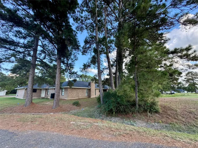 a view of a house with a tree and a yard