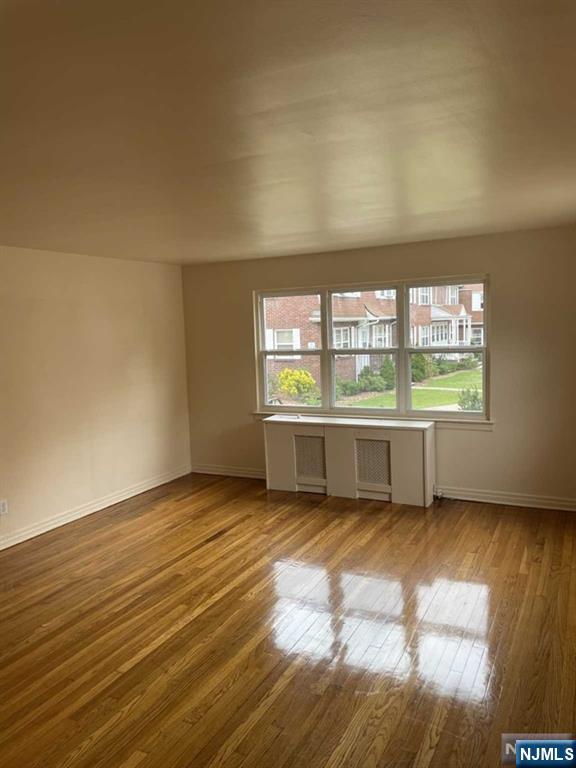 2 Mount Vernon Court Maywood, NJ 07607 - Photo 5 of 28 a view of an empty room with a window and wooden floor