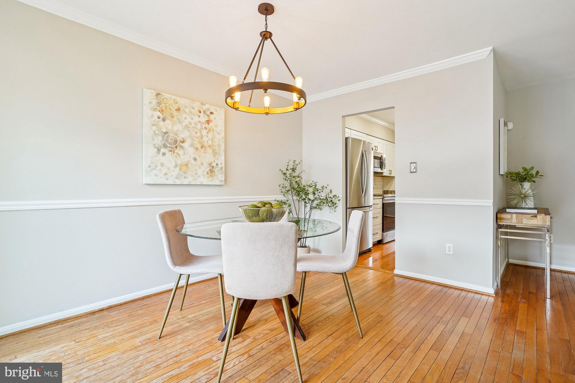 8826 Surveyors Place Springfield, VA 22152 - Photo 14 of 40 a view of a dining room with furniture and wooden floor