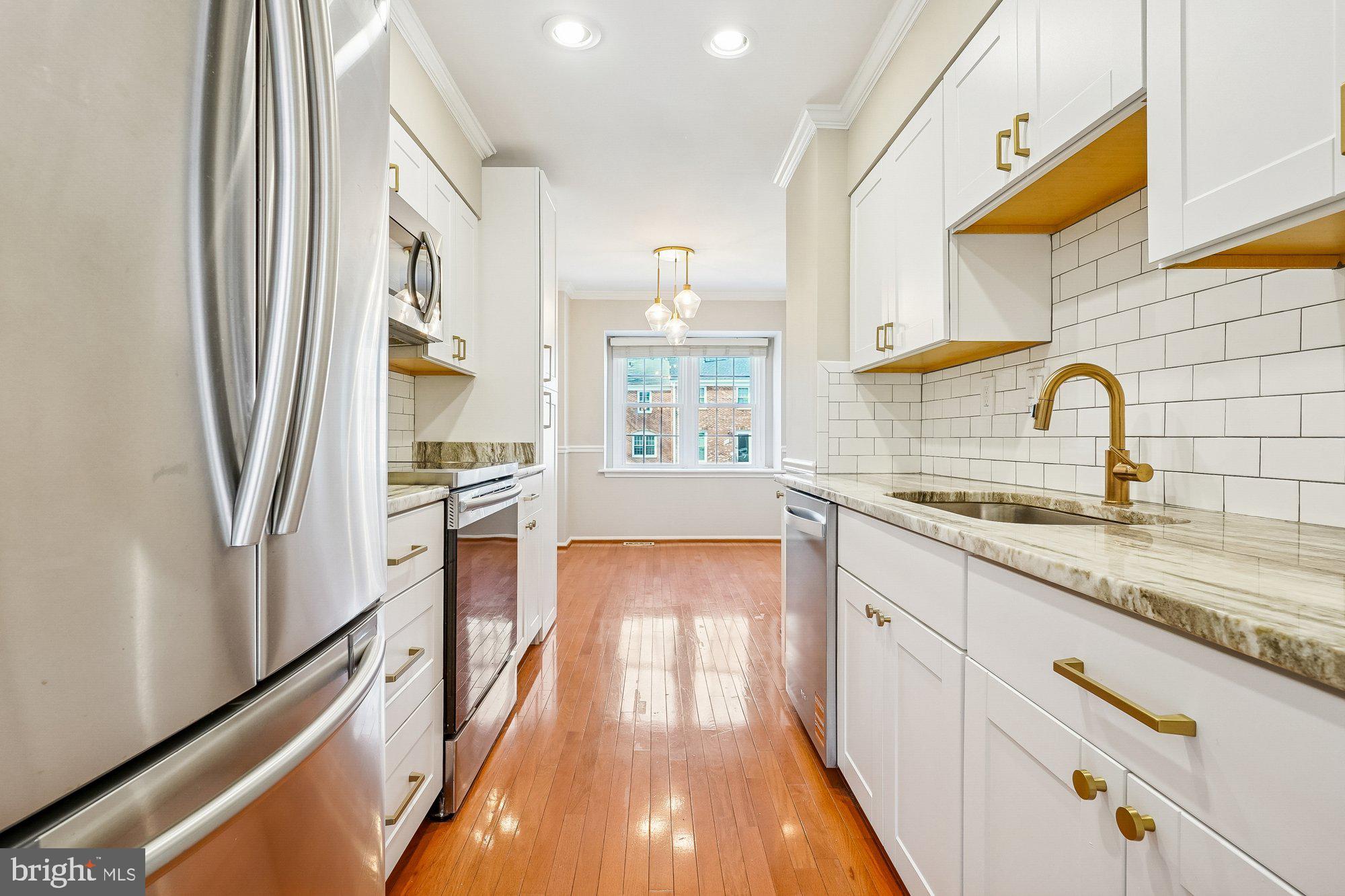 8826 Surveyors Place Springfield, VA 22152 - Photo 15 of 40 a view of a kitchen with a sink and wooden floor