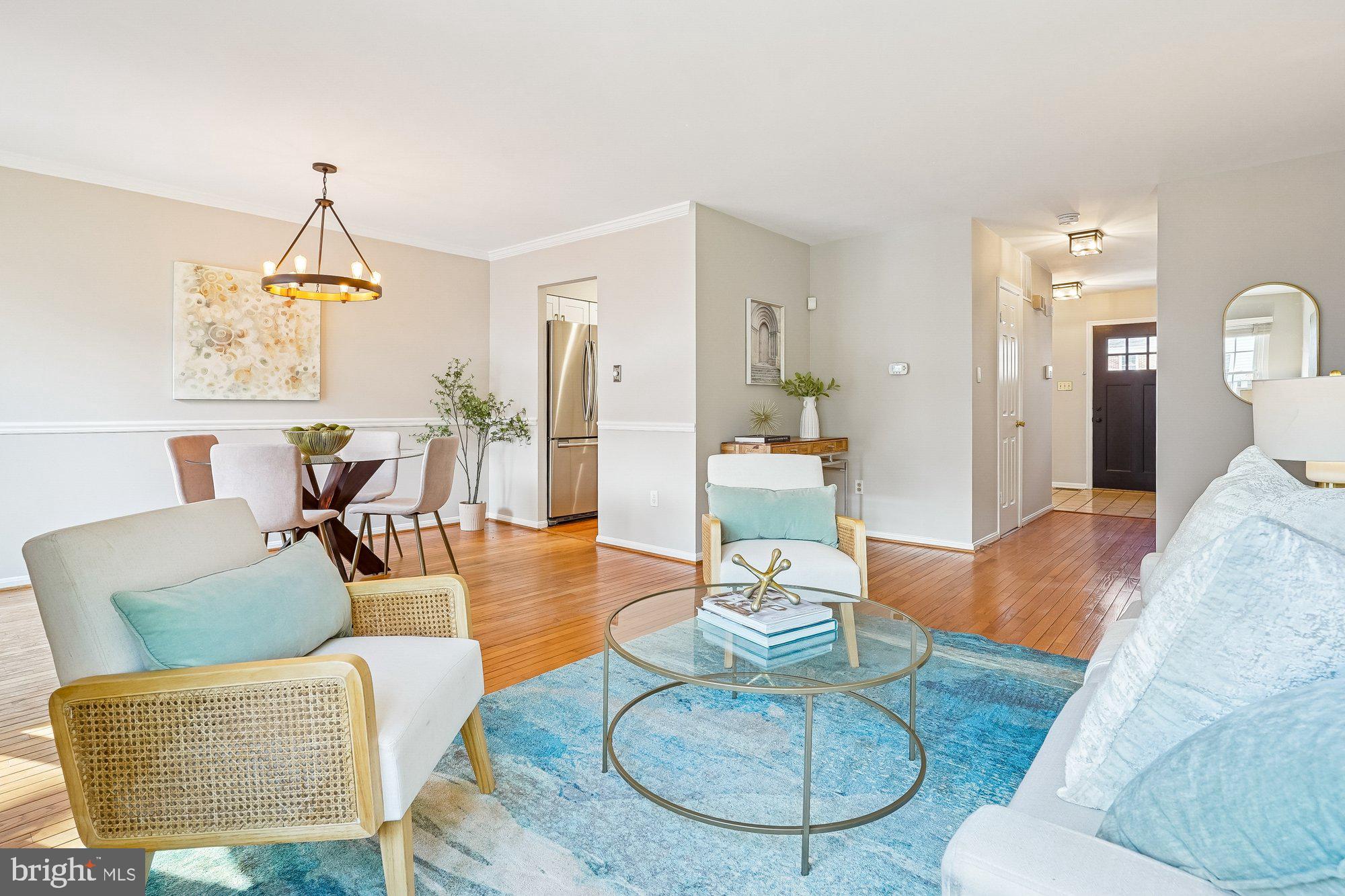 8826 Surveyors Place Springfield, VA 22152 - Photo 39 of 40 a living room with furniture a rug and a chandelier