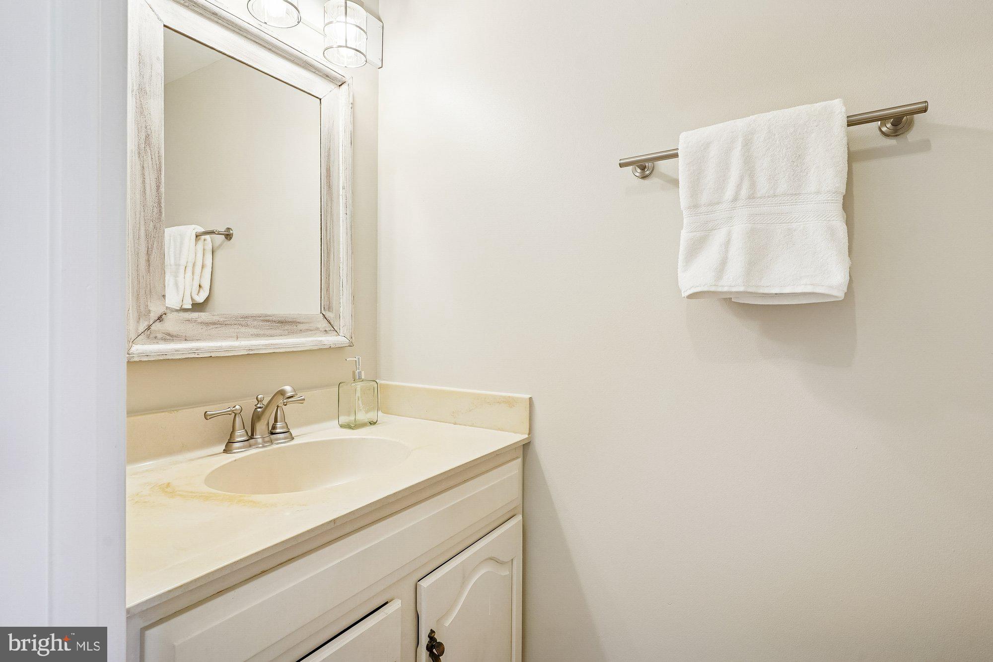 8826 Surveyors Place Springfield, VA 22152 - Photo 20 of 40 a bathroom with a sink vanity and mirror