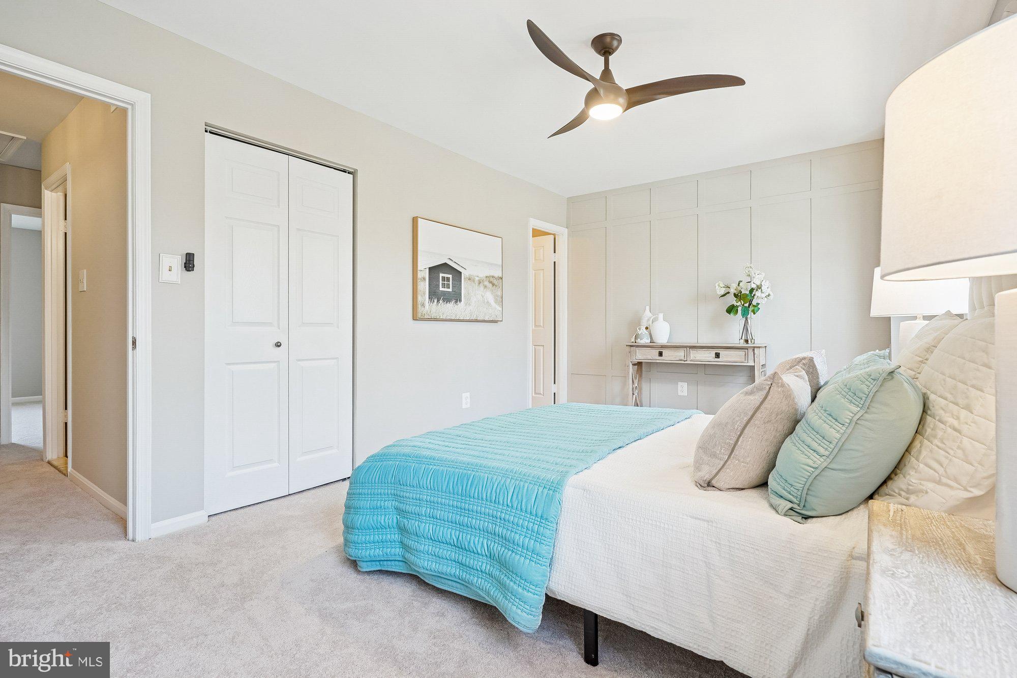 8826 Surveyors Place Springfield, VA 22152 - Photo 21 of 40 a bedroom with a bed a ceiling fan and a dresser