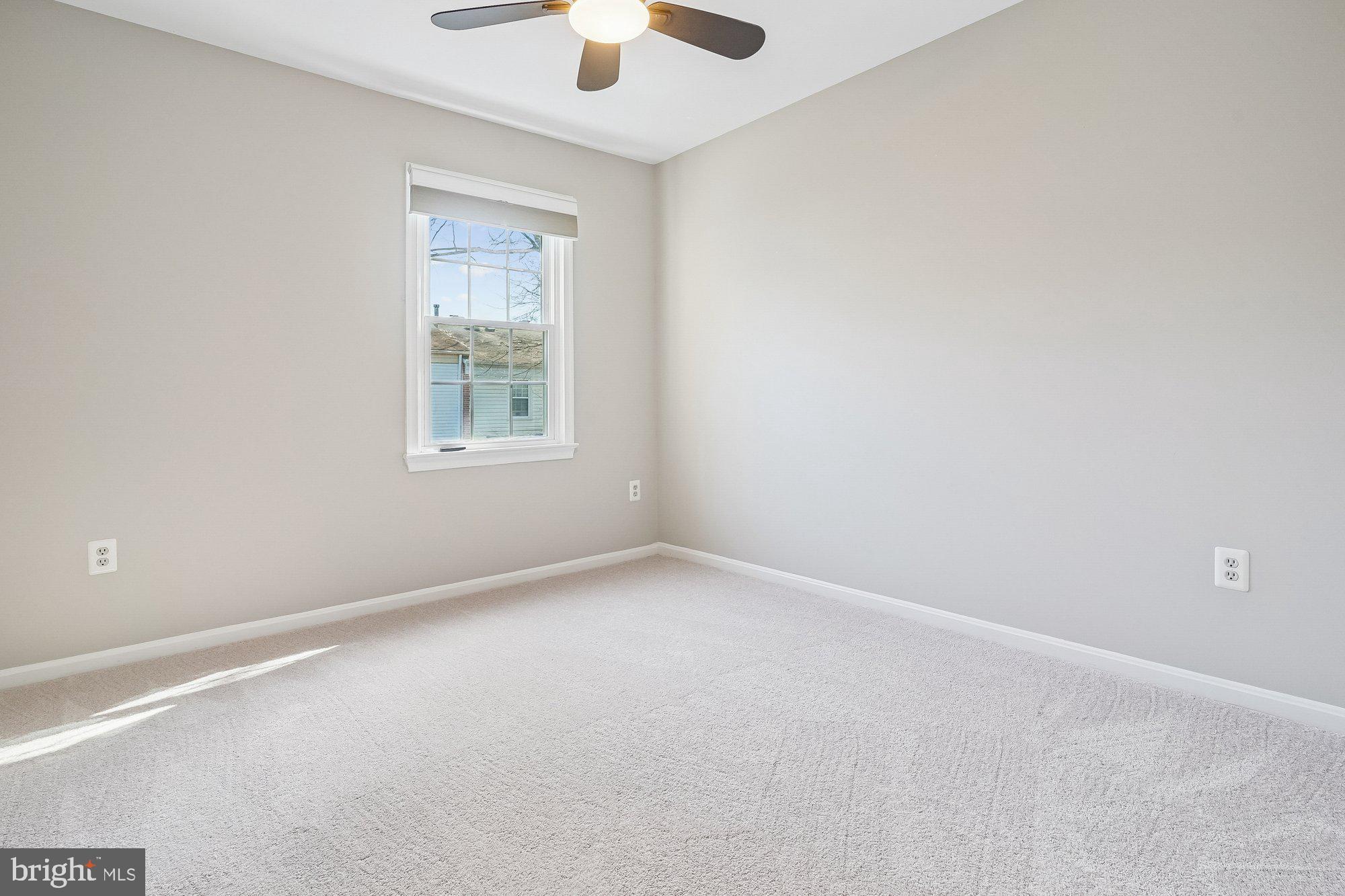 8826 Surveyors Place Springfield, VA 22152 - Photo 24 of 40 an empty room with a window and a fan