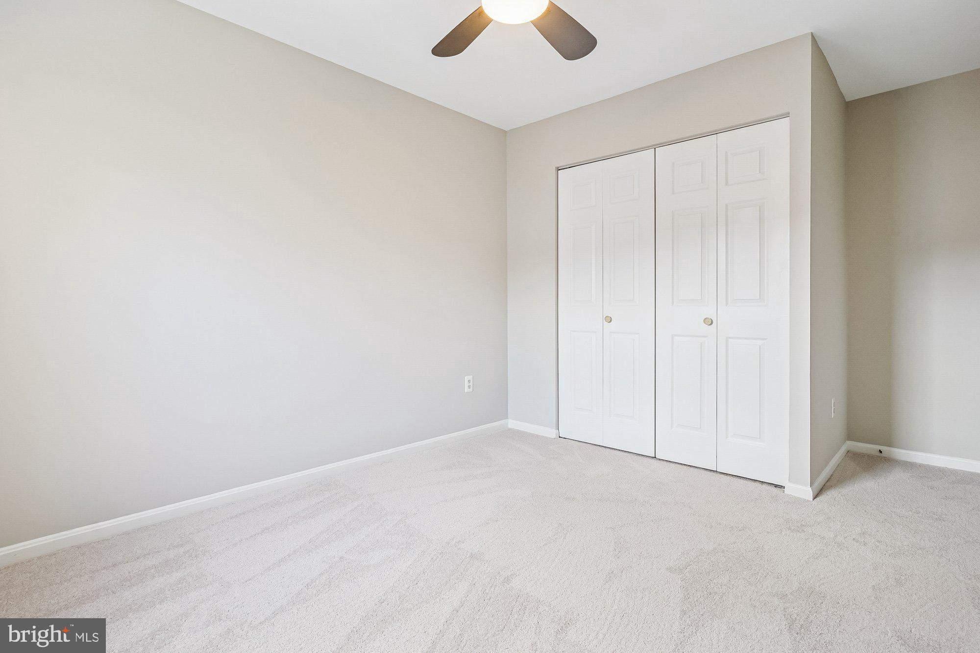 8826 Surveyors Place Springfield, VA 22152 - Photo 25 of 40 an empty room with closet and a chandelier fan