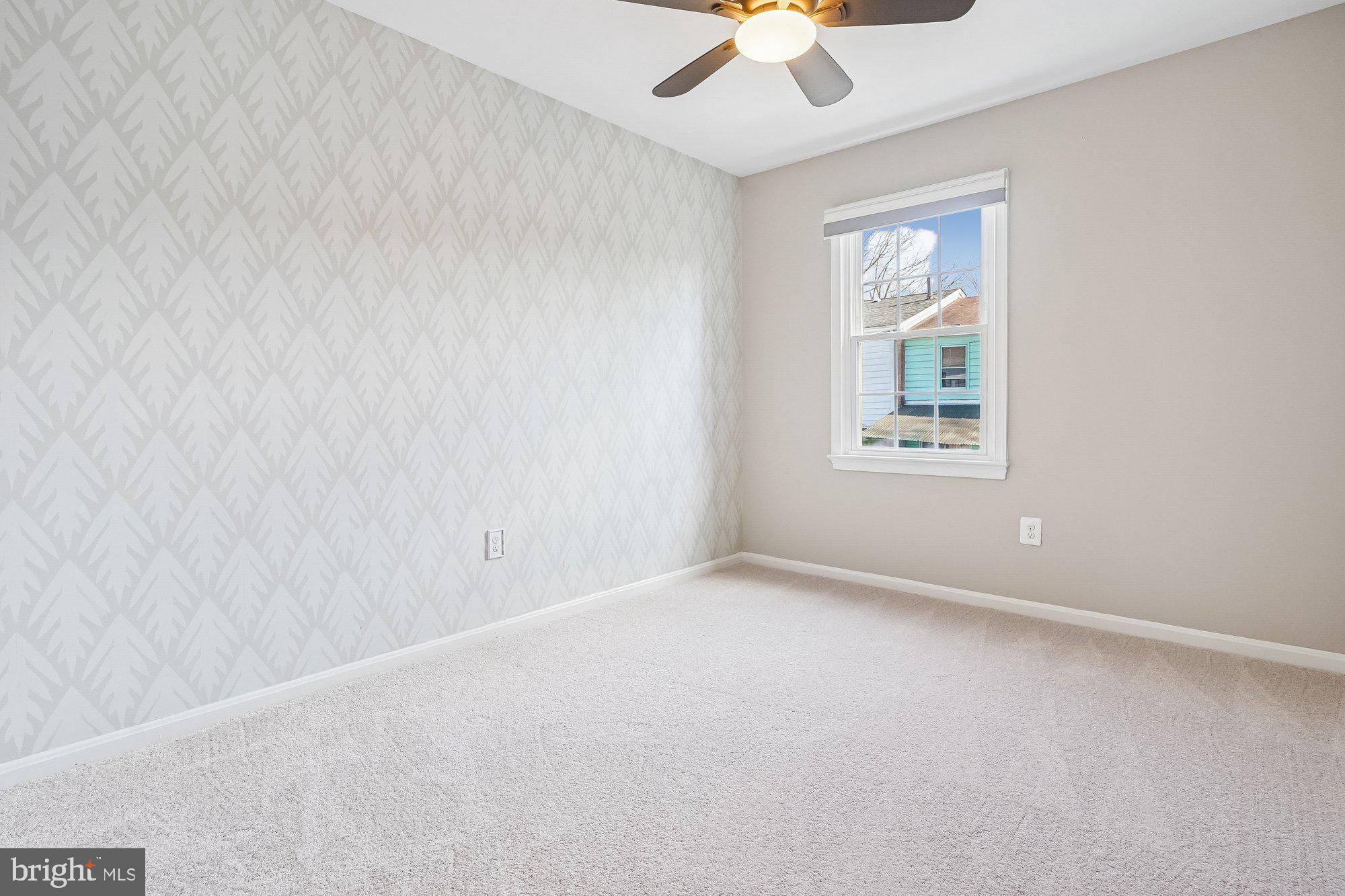 8826 Surveyors Place Springfield, VA 22152 - Photo 26 of 40 an empty room with a chandelier fan