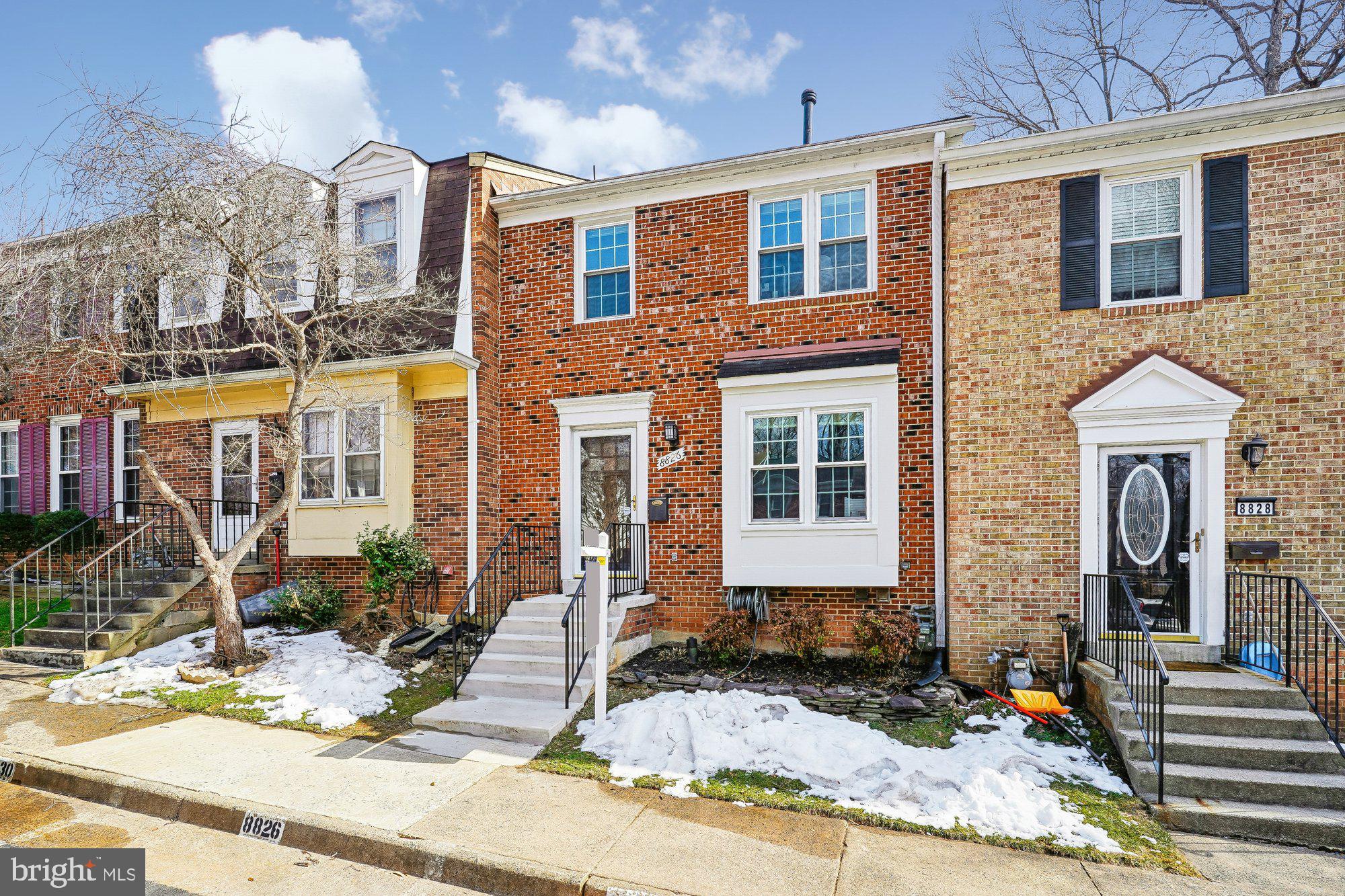 8826 Surveyors Place Springfield, VA 22152 - Photo 6 of 40 a front view of a house with yard and seating space