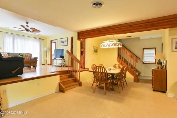 a view of a dining room with furniture and a chandelier